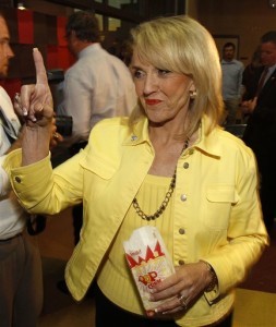 Gov. Jan Brewer flashes the "number one" sign as she joins proponents of Prop. 100. (AP Photo/Ross D. Franklin)