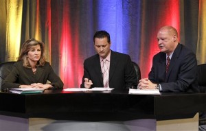 As debate moderator Rich Dubek looks down, Arizona Attorney General candidates Tom Horne, right, a Republican, answers a question as Felecia Rotellini, left, a Democrat, looks on during a debate sponsored by Valley Leadership, Wednesday, Oct. 6, 2010, in Phoenix. (AP Photo/Ross D. Franklin)