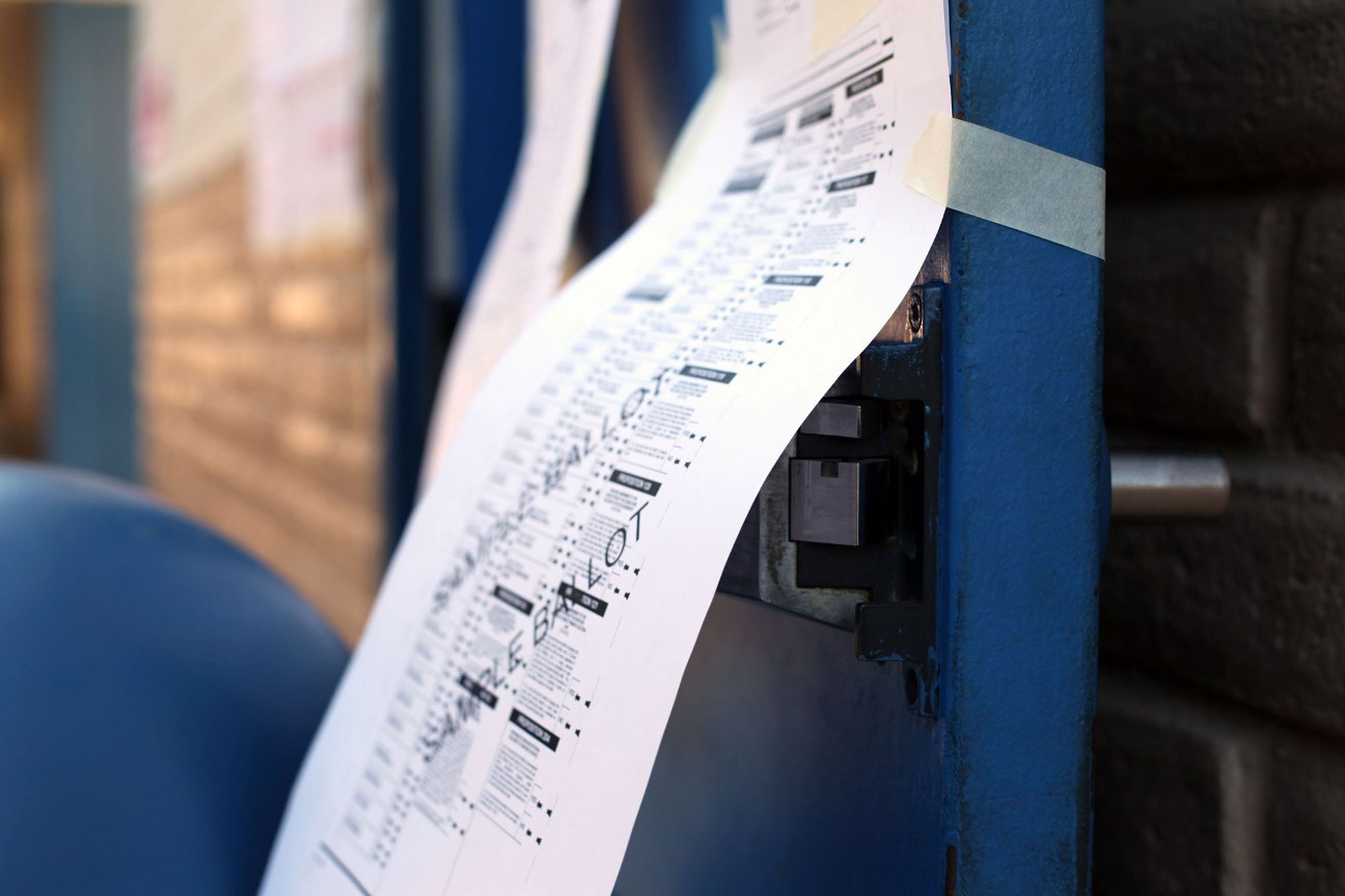 A sample ballot hangs outside the polling precinct Tuesday at Peralta Elementary school in west Phoenix. (Cronkite News Service Photo by Natasha Khan)