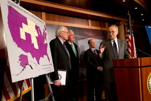 In this Dec. 6, 2012, photo, Sen. Charles Schumer, D-N.Y., right, accompanied by from left, Sen. Bernard Sanders, I-Vt., Sen. Tom Harkin, D-Iowa, and Sen. Chris Coons, D-Del., gestures during a news conference the possibility of Americans abruptly their jobless benefits at the of the year on Capitol Hill in Washington, Hovering in the background of the "fiscal cliff" debate is the prospect of 2 million people losing their unemployment benefits four days after Christmas. (AP Photo/Jacquelyn Martin)