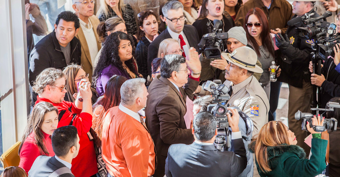 Protestors congregated in the lobby of the Arizona House of Representatives on the first day of the 2013 legislative session, resulting in three arrests. (Photo by Ryan Cook/RJ Cook Photography)