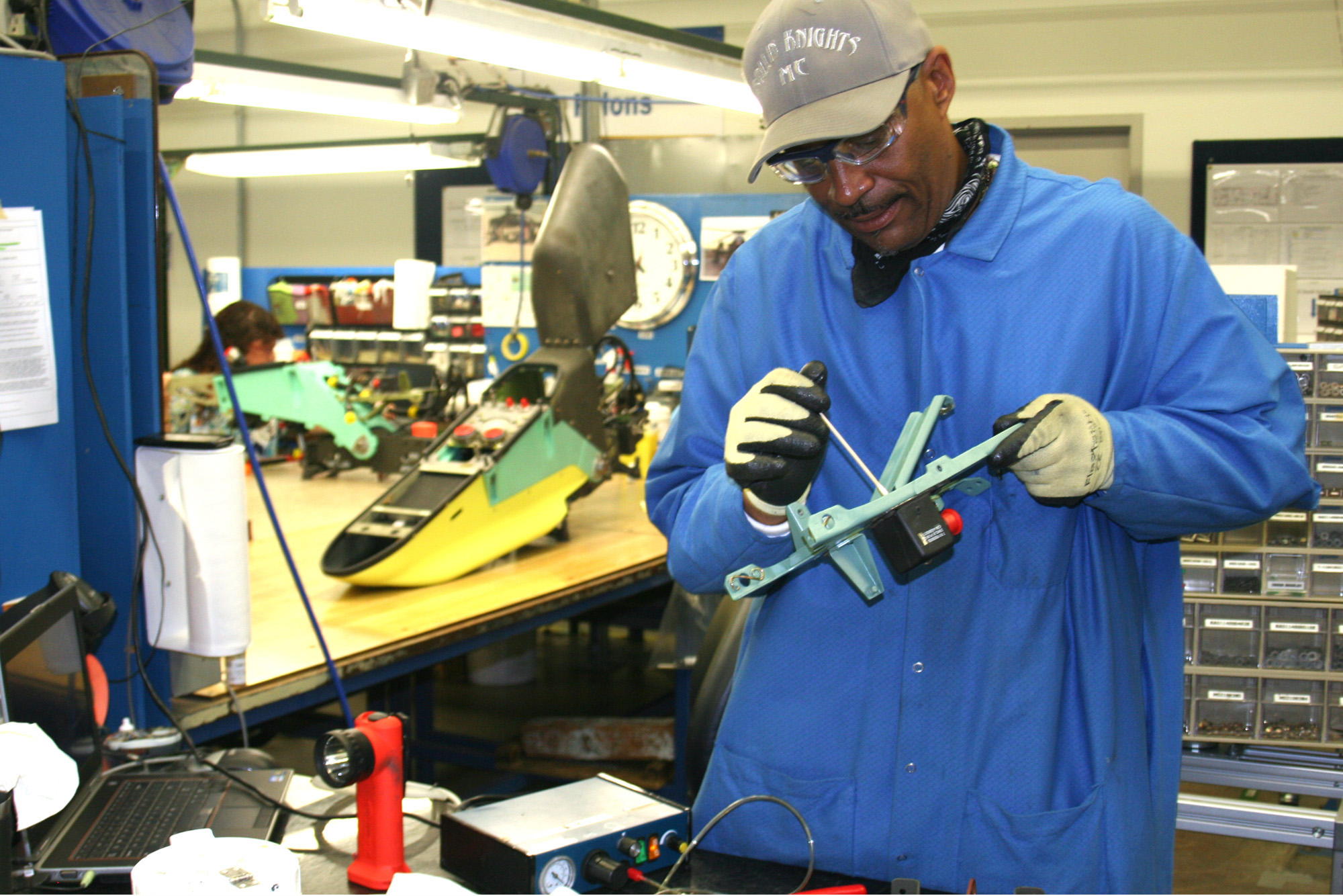 Ronald Young, an employee at Boeing’s plant in Mesa, fashions a pylon used to hold weapons on the AH64D attack helicopter (Cronkite News Service photo by Sarah Pringle)