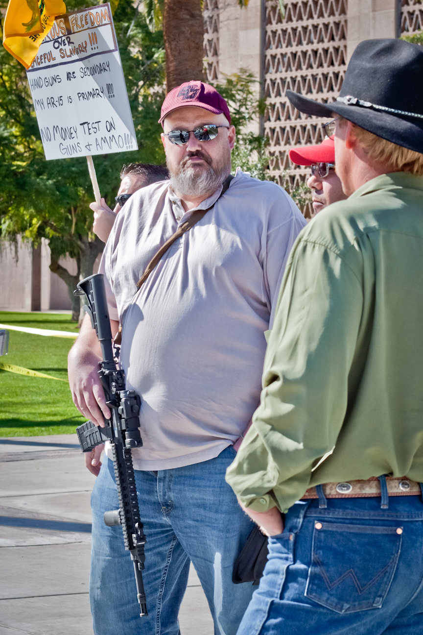 Anthem resident Keith Dale carries his AR-15 rifle across his chest and his 9mm pistol on his hip Friday at the Arizona Capitol. (Photo by Evan Wyloge/Arizona Capitol Times)