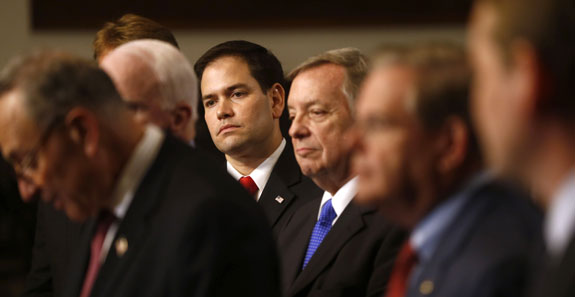 In this April 18, 2013 file photo, Sen. Marco Rubio, R-Fla., center, and other members of immigration reform's bipartisan "Gang of Heat," appear at a Capitol Hill news conference in Washington. Passage of the landmark immigration bill won't be simple. Presidential ambitions alone will see to that, as Rubio, for one, attempts a political straddle while other potential GOP presidential candidates firmly oppose the measure. Rubio, who helped negotiate the bipartisan bill, has recently called for changes as he tries to keep faith with tea party supporters and other conservatives who will vote in the 2016 primaries and caucuses. Speaking at left is Sen. Charles Schumer, D-N.Y. (AP Photo/Charles Dharapak, File)