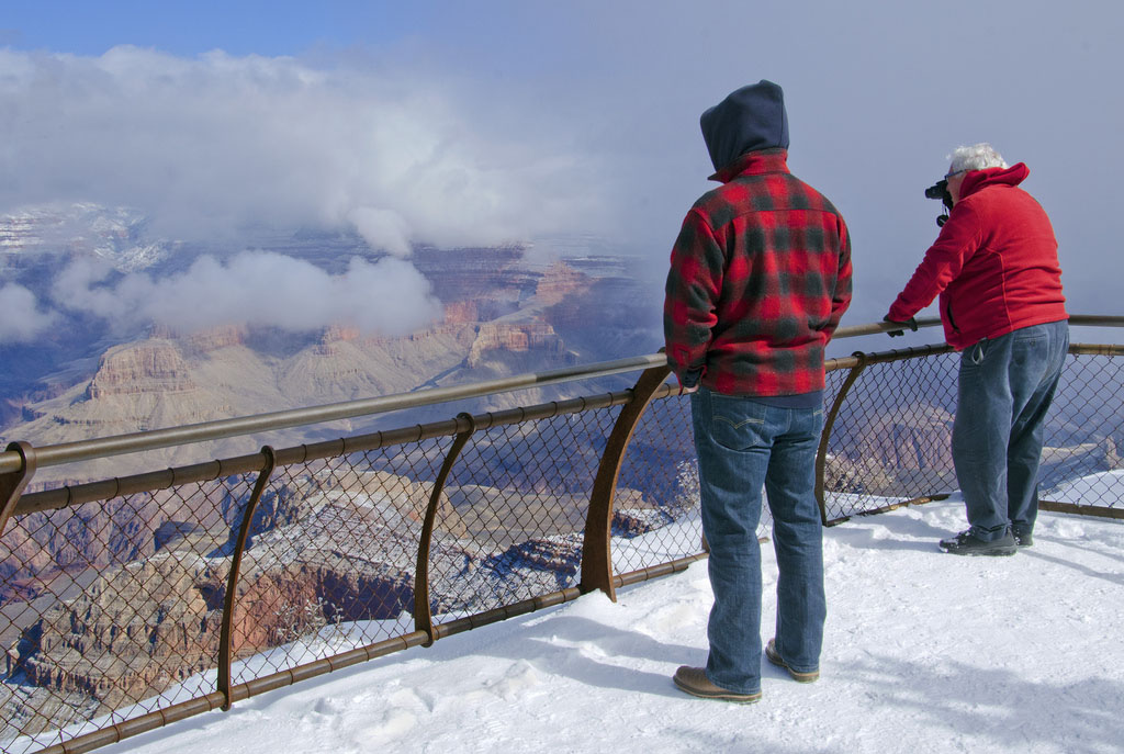 Visitors to Mather Point on the South Rim watch as a storm breaks in the Grand Canyon in this February photo. (Photo by Michael Quinn/National Park Service)