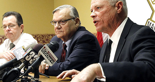 In this Dec. 5, 2011 file photo, Maricopa County Sheriff Joe Arpaio, center, listens as Chief Deputy Jerry Sheridan, right, discusses the latest in the document release on his office's handling of many sexual assault cases over the years in El Mirage, Ariz., during a news conference in Phoenix. Arpaio and his top aide Sheridan are required to appear before a federal judge who believes the two have mischaracterized and trivialized the judge's key findings in a racial-profiling decision issued in 2013 against the police agency. The sheriff's office will be required to provide answers Monday, March 24, 2014 to U.S. District Judge Murray Snow about an Oct. 18 training session in which the judge said Sheridan appears to suggest that rank-and-file deputies weren't obliged to make their best efforts to remedy the agency's constitutional violations. (AP Photo/Ross D. Franklin, File)