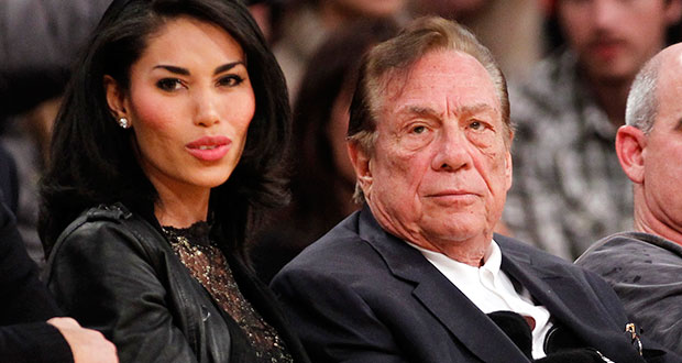 In this Dec. 19, 2010, file photo, Los Angeles Clippers owner Donald Sterling, third right, sits with V. Stiviano, left, as they watch the Clippers play the Los Angeles Lakers during an NBA preseason basketball game in Los Angeles. NBA commissioner Adam Silver announced Tuesday, April 29, 2014, that he is banning the owner for life from the Clippers organization over racist comments in recording. (AP Photo/Danny Moloshok, File)