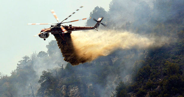 A helicopter battling the Slide Fire in Coconino National Forest which cost $10.2 million to contain as it burned more than 20,000 acres. The fire, which started May 20, was fully contained this week. (Photo by Mark Brady/U.S. Forest Service)