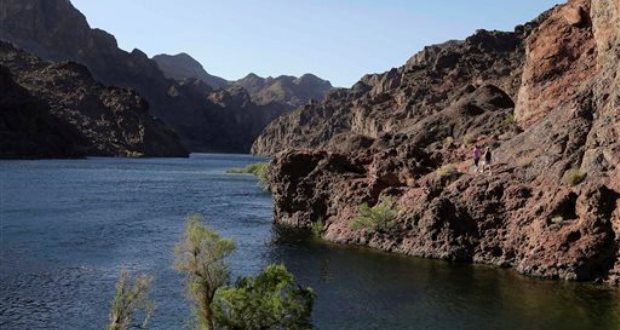 Hikers make their way along the banks of the Colorado River in Black Canyon south of Hoover Dam, Sunday, April 14, 2013, near Willow Beach, Ariz. (AP Photo/Julie Jacobson)