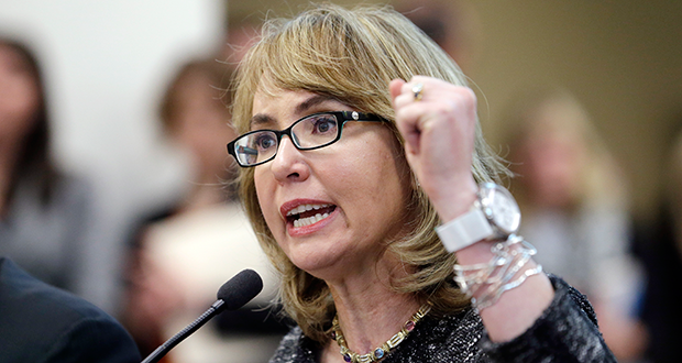 FILE - In this Jan. 28, 2014, file photo, former Arizona Congresswoman Gabrielle Giffords pumps her fist as she testifies before a Washington state House panel in Olympia, Wash. Giffords will begin a nine-state tour in Maine on Tuesday, Oct. 14, 2014, where she will advocate for tougher gun laws that she says will help protect women and families. Giffords, who was severely wounded by a gunman in 2011, will seek to elevate the issue of gun violence against women and push for state and federal action to make it more difficult for domestic abusers to get a hold of firearms. (AP Photo/Elaine Thompson, File)