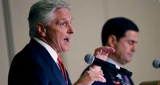 Arizona democratic gubernatorial candidate Fred DuVal speaks as republican candidate Doug Ducey listens, Tuesday, Oct 13, 2014 during a debate for the Arizona Women's Forum in Scottsdale, Ariz. (AP Photo/Matt York)