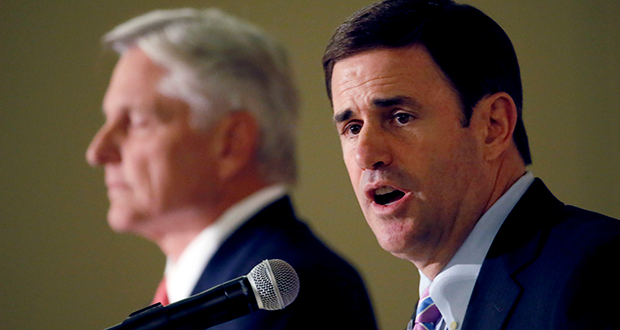 Arizona Republican gubernatorial candidate Doug Ducey speaks as democratic candidate Fred DuVal listens, Tuesday, Oct 13, 2014 during a debate for the Arizona Women's Forum in Scottsdale, Ariz. (AP Photo/Matt York)