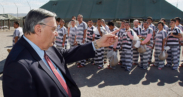 In this February 4, 2009, file photo, Maricopa County Sheriff Joe Arpaio orders approximately 200 convicted illegal immigrants handcuffed together and moved into a separate area of Tent City for incarceration until their sentences are served and they are deported to their home countries. (AP Photo/Ross D. Franklin)