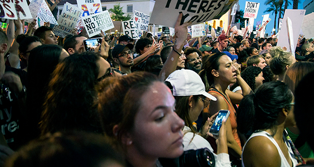 Protesters demonstrate at the August 22 campaign rally for President Trump. Phoenix police made a handful of arrests and used tear gas and pepper spray to disperse the crowd as the event came to a close. (Arizona Capitol Times/Photo by Ellen O'Brien)