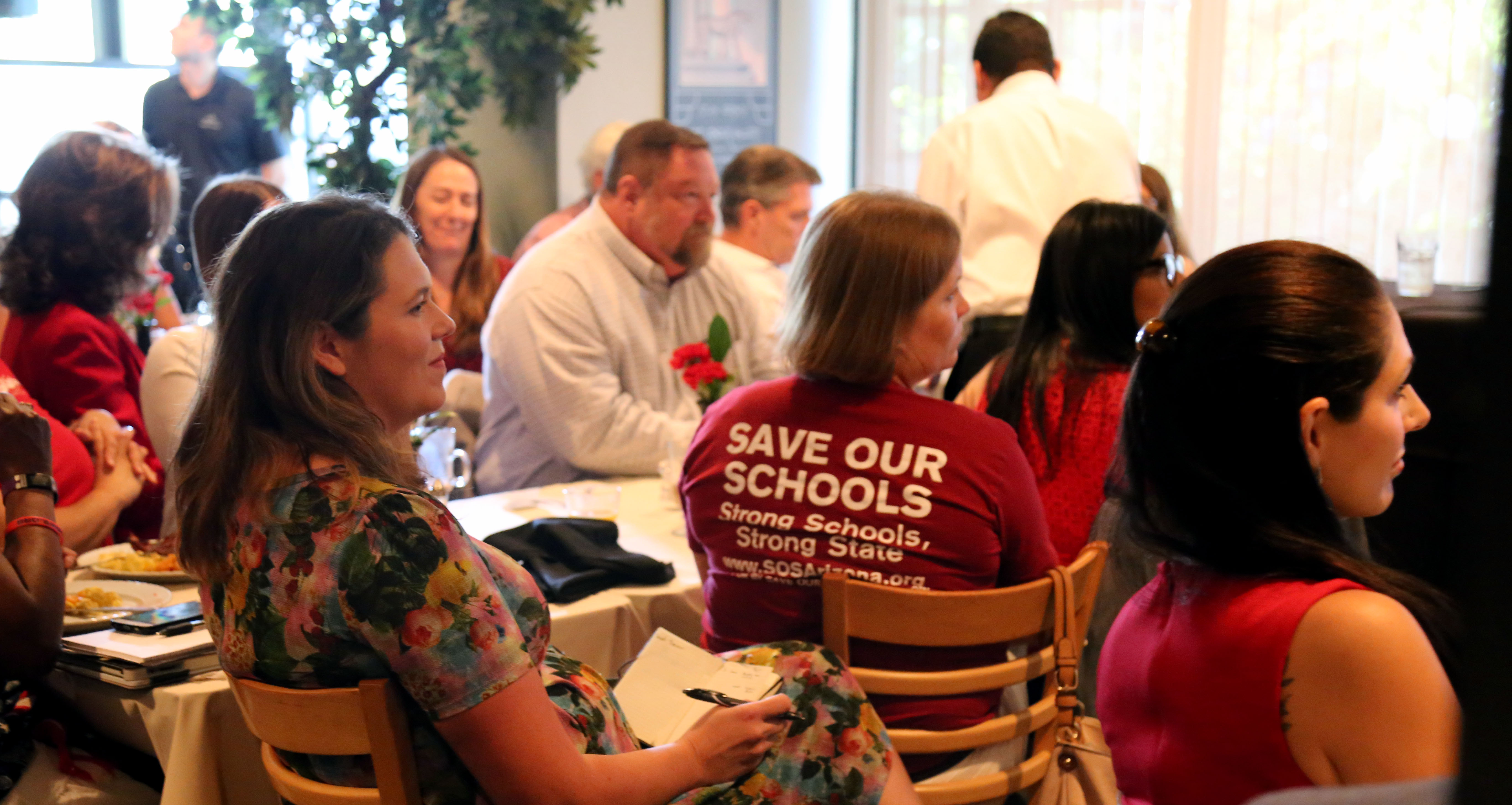 Save Our Schools Arizona supporters sit in the audience of the Arizona Capitol Times Morning Scoop on school choice on Sept. 19. (Photo by Katie Campbell/Arizona Capitol Times)