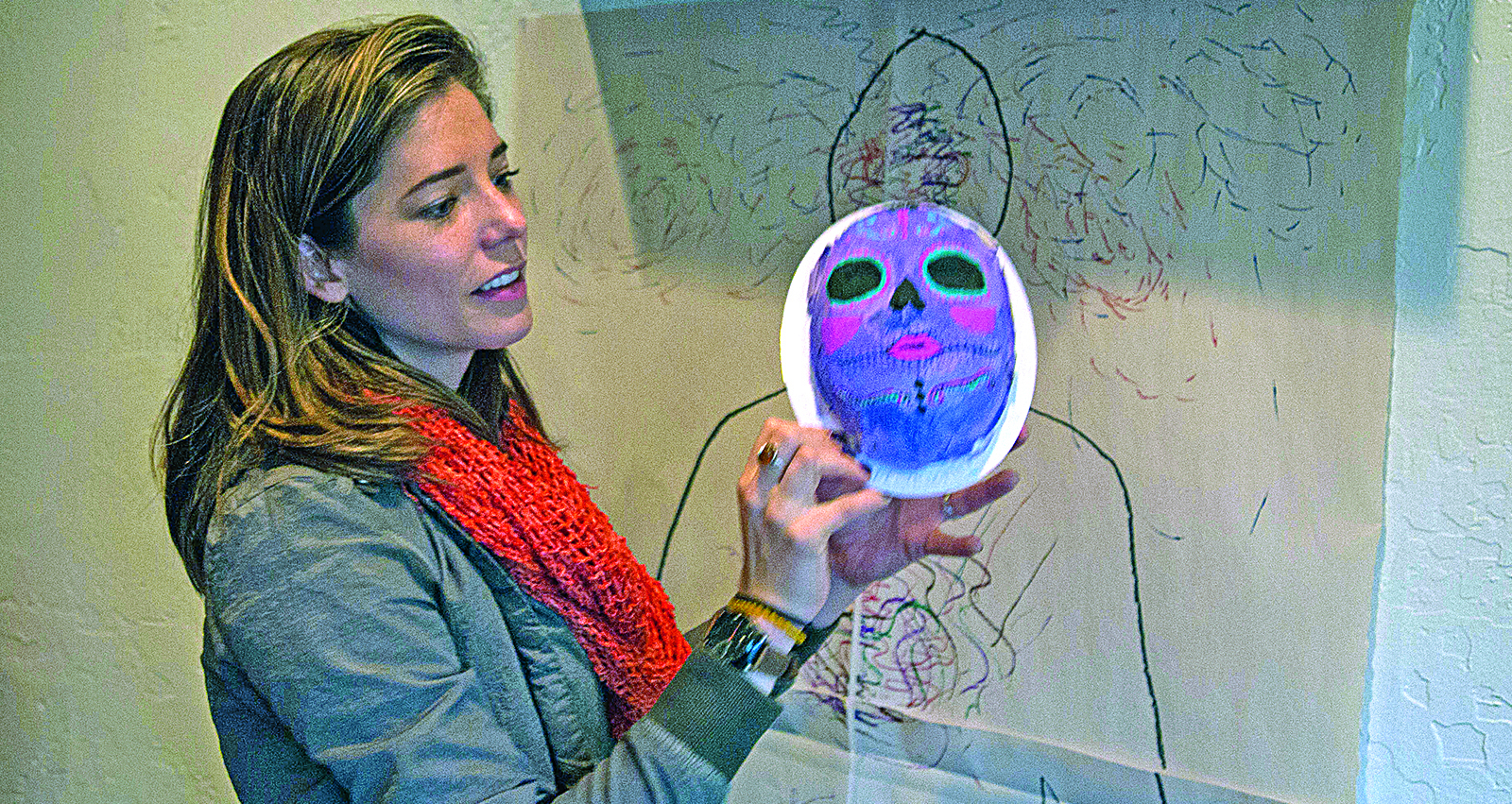 Art therapist Natalie Foster looks through some of the art in her office made by patients. (Photo by Jenna Miller/Arizona Capitol Times)