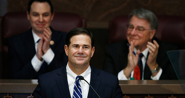 Arizona Republican Gov. Doug Ducey, middle, pauses as he gives his state of the state address as he is flanked by House Speaker J.D. Mesnard, left, R-Chandler, and Senate President Steve Yarbrough, right, R-Chandler, at the capitol, Monday, Jan. 8, 2018, in Phoenix. (AP Photo/Ross D. Franklin)