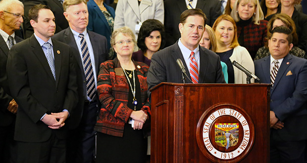 Gov. Doug Ducey, flanked by education officials and legislative leaders, announces his plan to put $100 million into additional assistance for districts in the 2019 budget. (Photo by Rachel Leingang, Arizona Capitol Times)