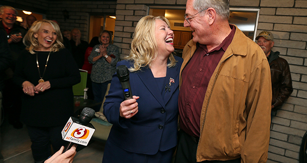 Republican candidate and former Arizona state Sen. Debbie Lesko celebrates with her husband, Joe, after voting results show her victory in a special primary election for the Congressional District 8 seat during a campaign party at Lesko's home on Feb. 27, 2018, in Glendale. Former Gov. Jan Brewer watches. (AP Photo/Ralph Freso)