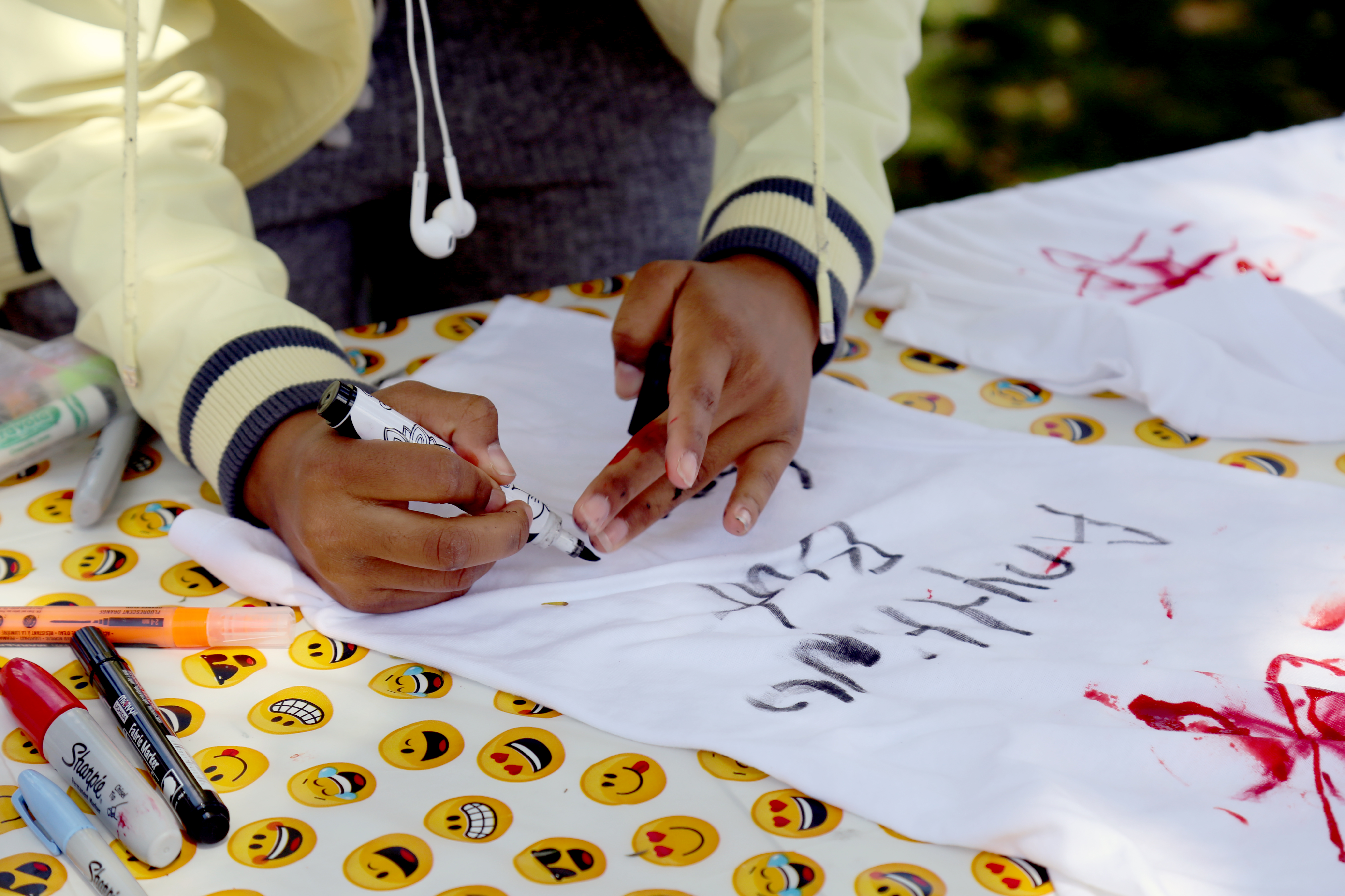 Grand Canyon University student Thameenah Muhammad, 17, prepares a T-shirt for a student protest against guns at the state Capitol. Students across the country participated in a March for Our Lives in the wake of the Parkland, Fla., shooting at Marjory Stoneman Douglas High School that left 17 people dead. (Photo by Katie Campbell/Arizona Capitol Times)