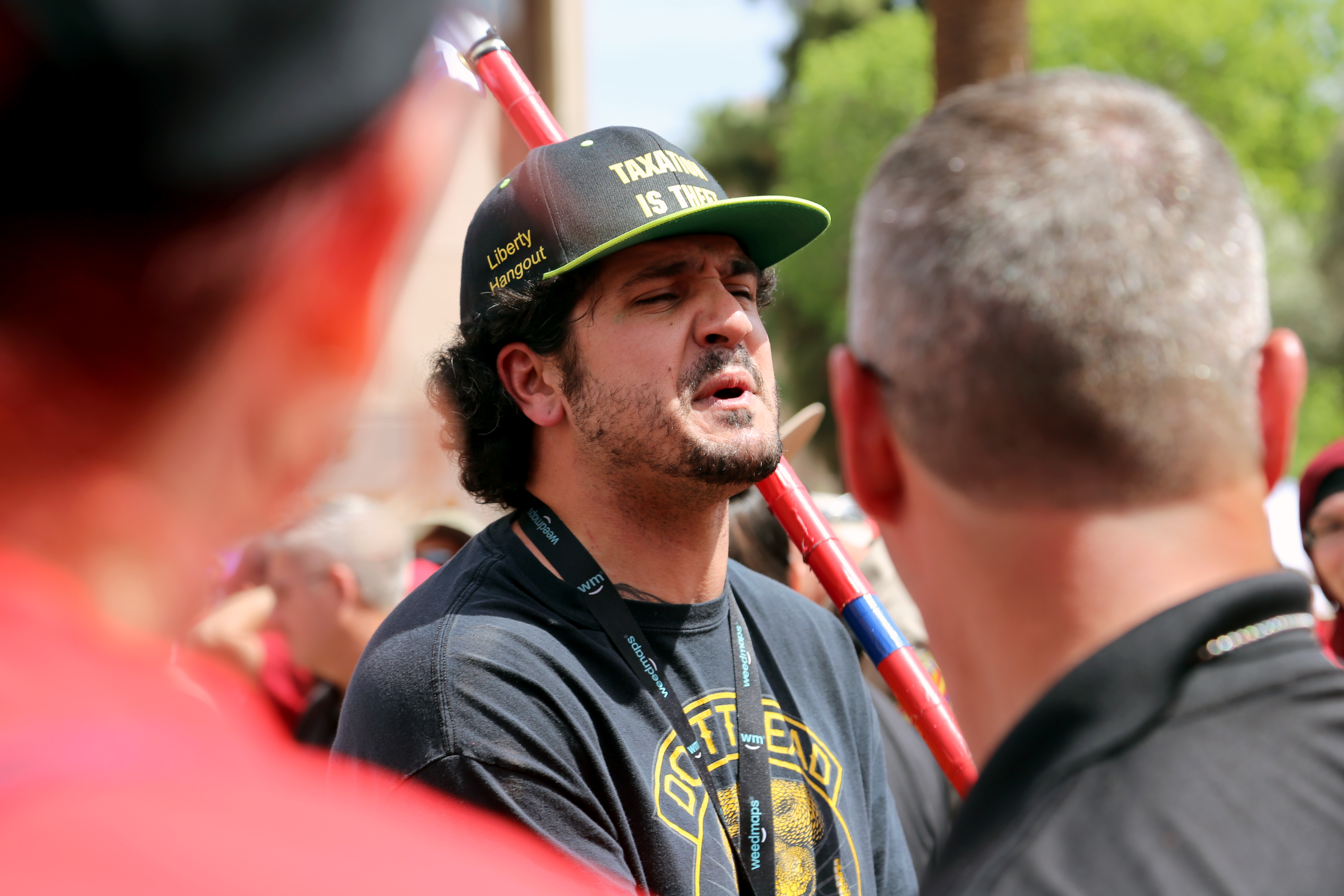 A member of Patriot Movement AZ, a controversial group of President Trump supporters, argues with Red for Ed protesters while Arizona Department of Public Safety officers keep the two groups separated on April 30. (Photo by Katie Campbell/Arizona Capitol Times)