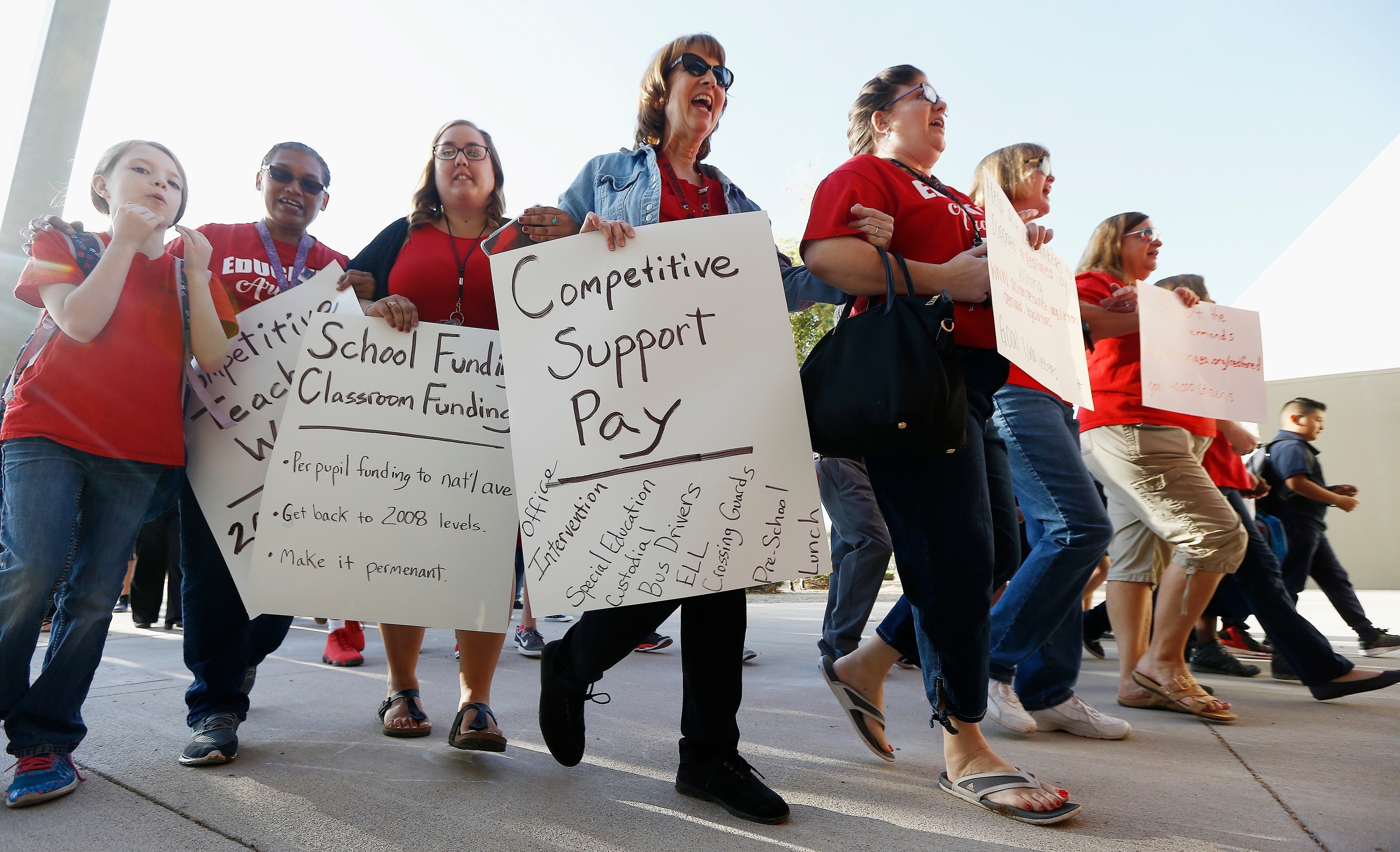 In this April 11 2018 file photo, teachers at Tuscano Elementary School stage a "walk-in" for higher pay and school funding in Phoenix. Arizona teachers began to vote Tuesday, April 17 on whether to walk off the job in their push for more funding for education. (AP Photo/Ross D. Franklin, File)