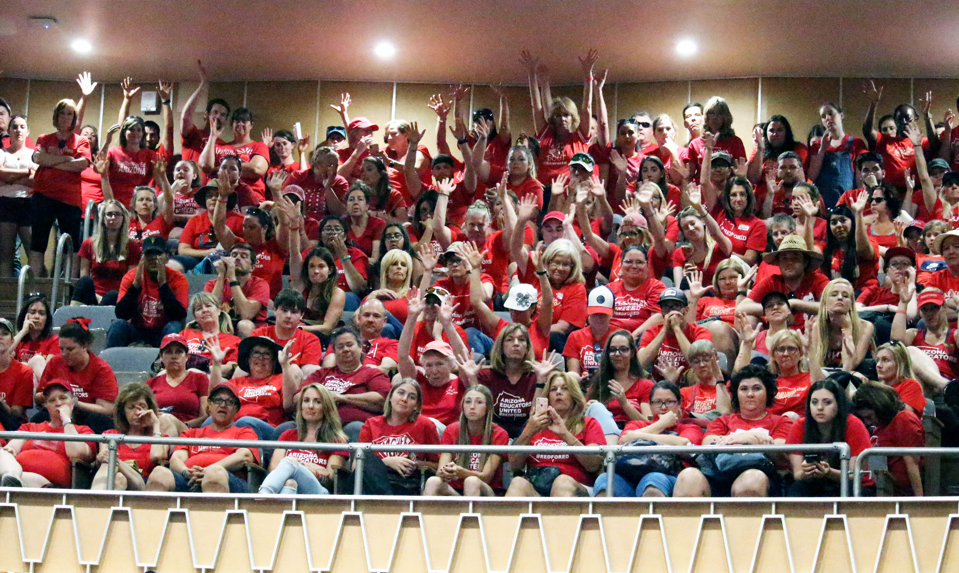 Striking teachers silently cheer using their hands to follow decorum on not clapping or verbally reacting from the Senate gallery while senators meet in Senate chambers on April 30, 2018. (AP Photo/Bob Christie)