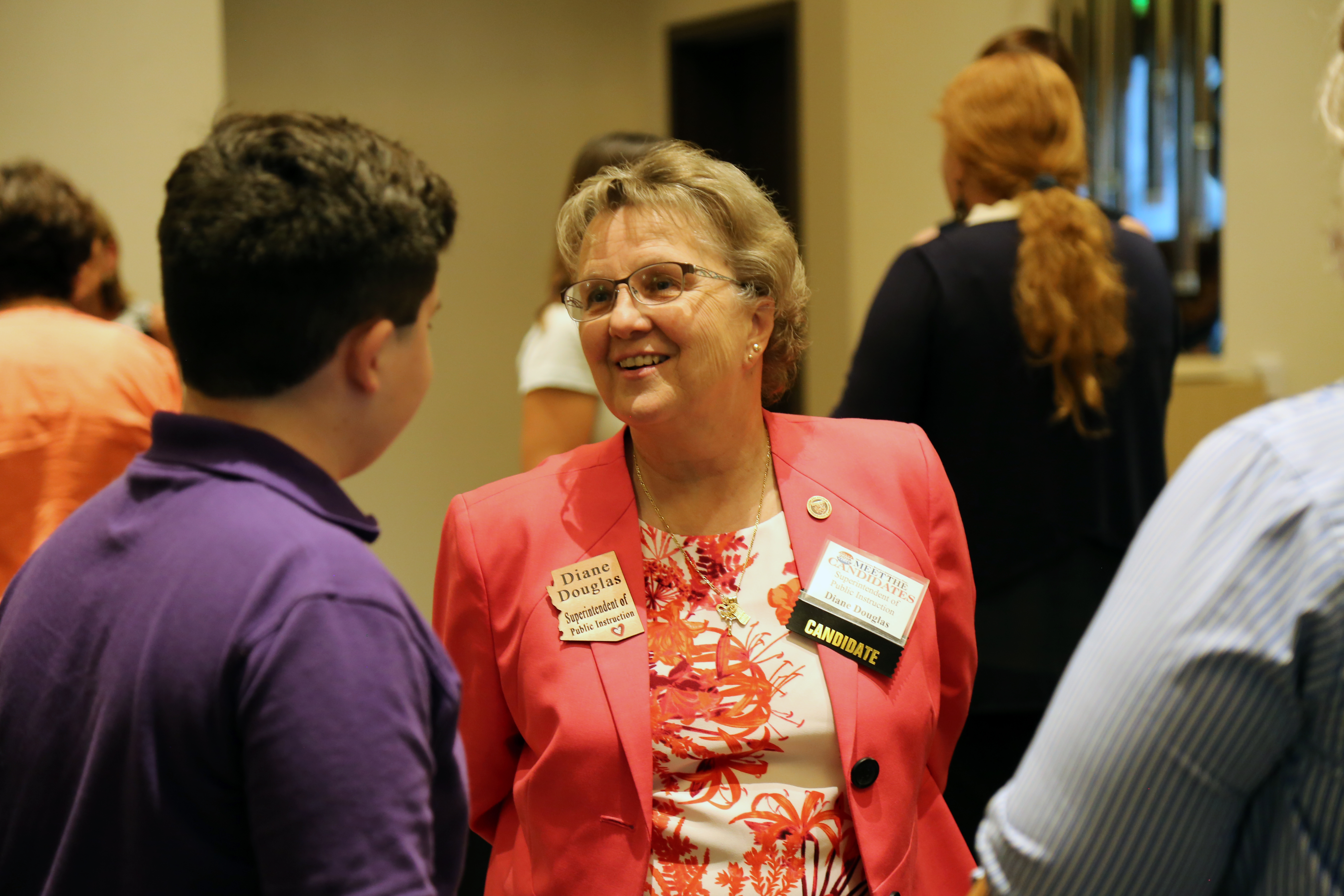 Superintendent of Public Instruction Diane Douglas chats with a constituent's son at the Arizona Capitol Times' Meet the Candidates event on Aug. 1. Douglas is seeking re-election this year, but she faces four Republican challengers in the August primary. PHOTO BY KATIE CAMPBELL/ARIZONA CAPITOL TIMES