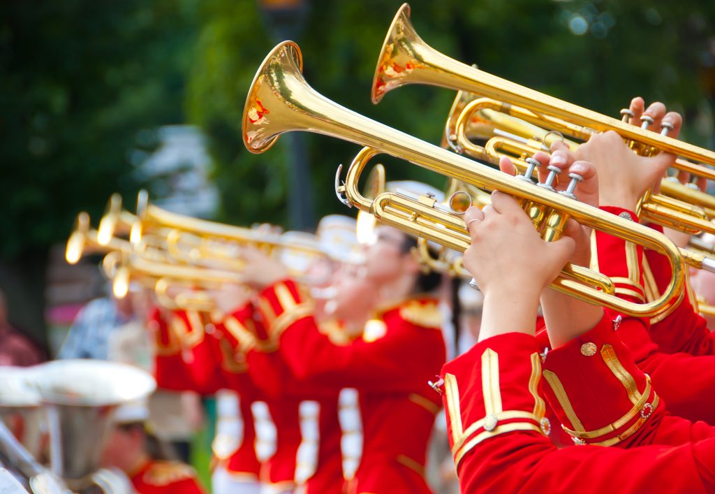 Girl Brass Band in red uniform performing