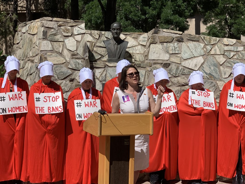 Kathy Brody, an attorney with the ACLU, speaks May 21 at a press conference at the Arizona Capitol, in which pro-choice advocates warned lawmakers not to introduce legislation to restrict abortion as legislatures in other states have. Women behind Brody are dressed in costumes from the Handmaid’s Tale, a television drama about a dystopia in which fertile women are slaves. (Photo by Andrew Howard/Arizona Capitol Times) 