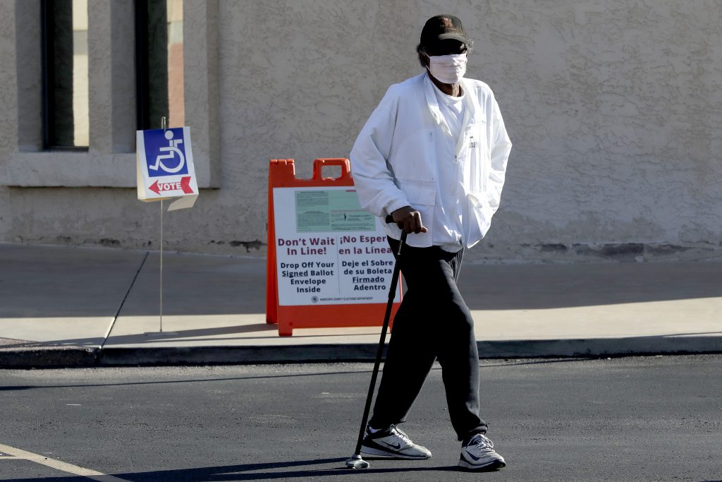 An Arizona voter leaves the polling station after casting his ballot in the Arizona presidential preference election Tuesday, March 17, 2020, in Phoenix. (AP Photo/Matt York)