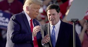 In this October 19, 2020, file photo, President Donald Trump pauses with Arizona Gov. Doug Ducey during a campaign rally in Tucson. Ducey spent much of Trump's presidency trying not to provoke confrontation with the president or his fervent defenders. When state law required Ducey to certify Arizona's presidential election results and sign off on Trump's defeat, four years of loyalty wasn't enough to protect him from the president. PHOTO BY ROSS D. FRANKLIN/ASSOCIATED PRESS