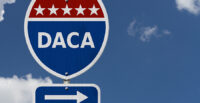 DACA USA Interstate highway sign, Red, white and blue interstate highway road sign with text DACA with sky background