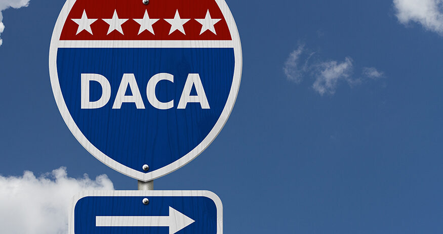 DACA USA Interstate highway sign, Red, white and blue interstate highway road sign with text DACA with sky background