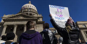 People gather in front of the Idaho Statehouse in opposition to anti-transgender legislation moving through an Idaho Republican congress, Friday, Feb. 24, 2023, in Boise, Idaho. The U.S. Supreme Court's decision on Monday, April 15, 2024, allows the state to put in place a 2023 law that subjects physicians to up to 10 years in prison if they provide hormones, puberty blockers or other gender-affirming care to people under age 18. A federal judge in Idaho had previously blocked the law in its entirety.