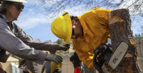 Aravaipa Hotshot Katie Williamson, left, instructs a Wildfire academy student using a chainsaw, Monday, March 11, 2024, in Prescott, Ariz. Forecasters are warning that the potential for wildfires will be above normal in some areas across the United States over the coming months as temperatures rise and rain becomes sparse.