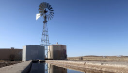 A windmill draws water for livestock in Leupp, Ariz., on the Navajo Nation, Saturday, March 9, 2024. A proposed water rights settlement for three Native American tribes that carries a price tag larger than any such agreement enacted by Congress took a significant step forward late Monday, May 13, with introduction in the Navajo Nation Council. (AP Photo/Felicia Fonseca)