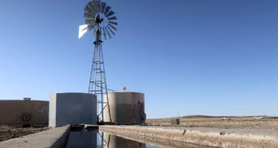 A windmill draws water for livestock in Leupp, Ariz., on the Navajo Nation, Saturday, March 9, 2024. A proposed water rights settlement for three Native American tribes that carries a price tag larger than any such agreement enacted by Congress took a significant step forward late Monday, May 13, with introduction in the Navajo Nation Council. (AP Photo/Felicia Fonseca)