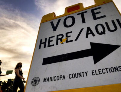 Voters deliver their ballot to a polling station in Tempe, Ariz., Nov. 3, 2020. (AP Photo / Matt York, File)