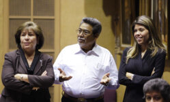 Sen. Amanda Aguirre, D-District-24, left, looks on as Sen. Manny Alvarez, D-District 25, gestures while talking with her and Sen. Rebecca Rios, D-District 23, on the Senate floor during a special session in the Arizona Senate at the state capitol on Nov. 19, 2009, in Phoenix. (AP Photo / Ross D. Franklin)